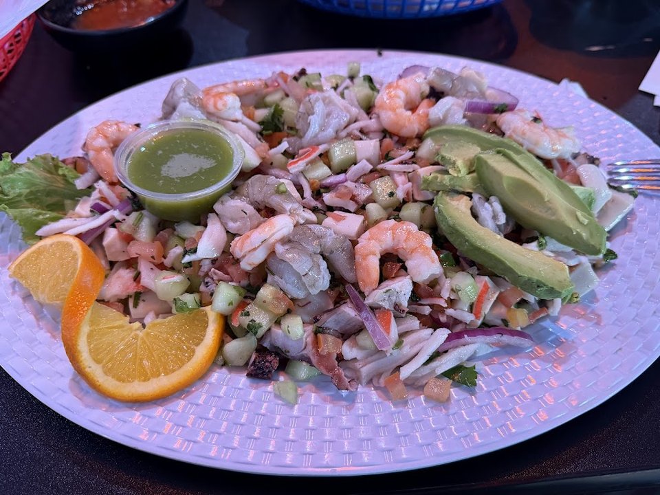 Printed menu featuring aguachiles and fajitas.